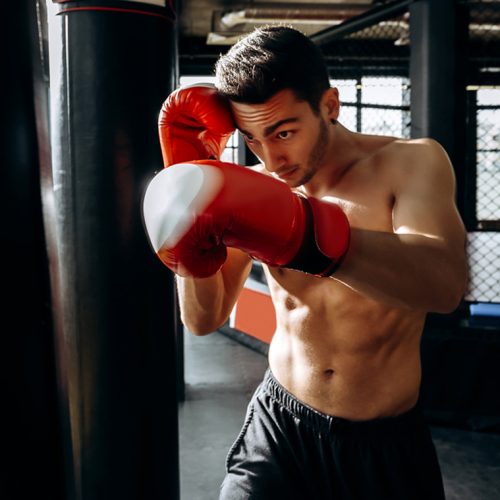 sportsman-in-red-boxing-gloves-with-a-naked-torso-W6GN2SR.jpg